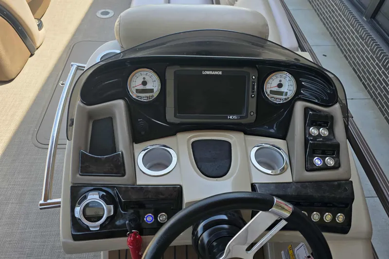 Slide: The Image of Dashboard of a 2015 Regency 254 LE3 boat with steering wheel and control panel. - 2