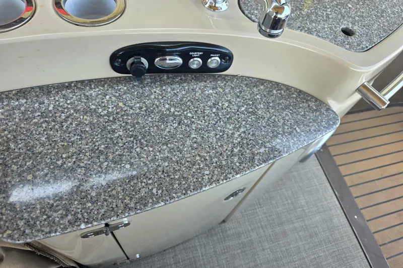 Slide: The Image of 2015 Regency 254 LE3 boat interior with granite countertop and control panel. - 3