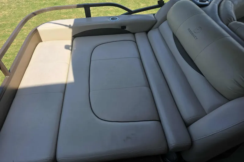 Slide: The Image of Luxurious seating on 2015 Regency 254 LE3 boat, featuring plush beige upholstery. - 4