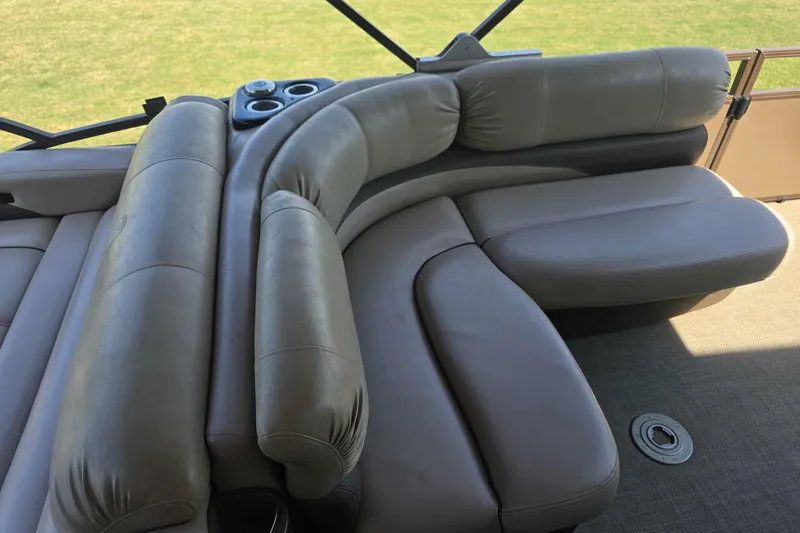 Slide: The Image of Luxurious seating on 2015 Regency 254 LE3 pontoon boat, featuring plush beige upholstery. - 5