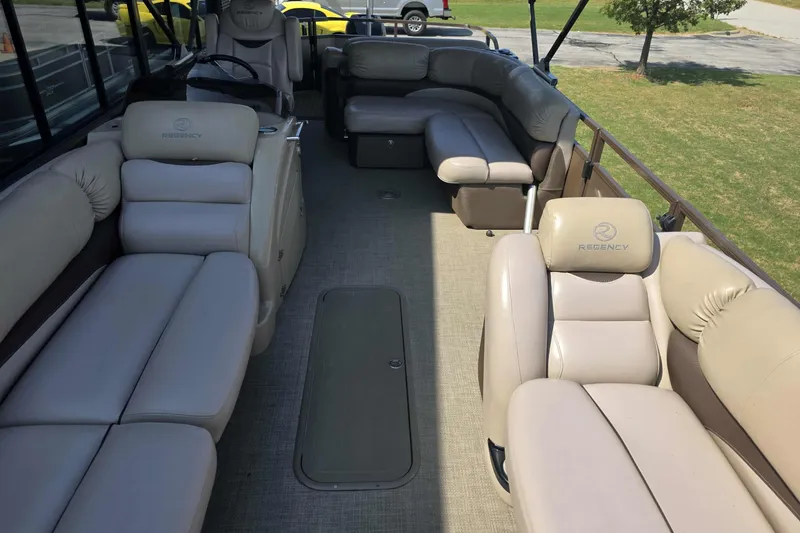 Slide: The Image of Luxurious 2015 Regency 254 LE3 pontoon boat interior with plush seating and spacious layout. - 7