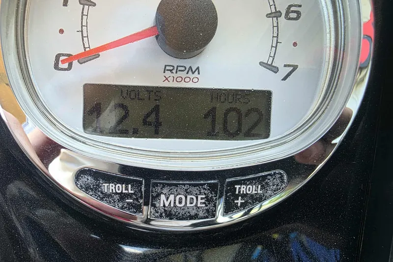 Slide: The Image of Close-up of a 2015 Regency 254 LE3 boat gauge showing 12.4 volts and 102 hours. - 9