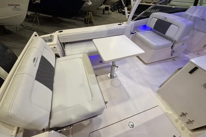 Slide: The Image of 2020 Cobia 280 Dual Console boat interior with seating and table, featuring modern design. - 14