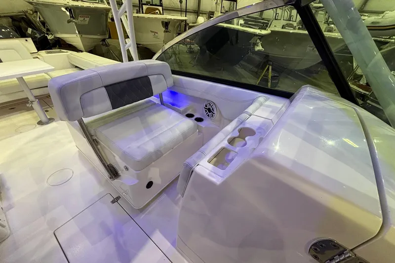 Slide: The Image of 2020 Cobia 280 Dual Console boat interior with seating and cup holders. - 16