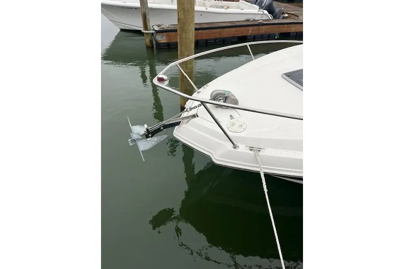 Slide: The Image of 2012 Chaparral 225 SSi boat anchored at a marina dock. - 17