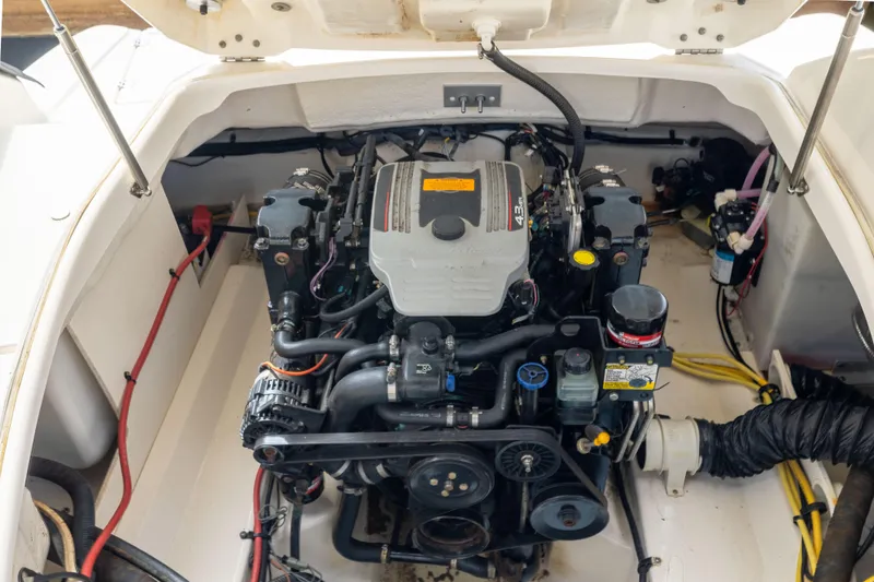 Slide: The Image of Engine compartment of a 2012 Chaparral 225 SSi boat, showcasing detailed mechanical components. - 19