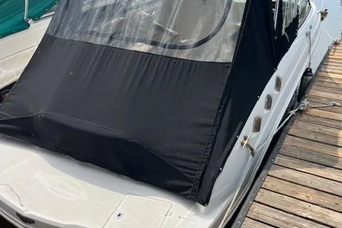 Slide: The Image of 2012 Chaparral 225 SSi boat docked with black canopy cover. - 3