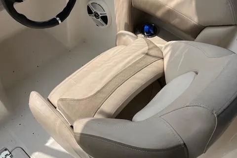 Slide: The Image of 2012 Chaparral 225 SSi boat interior with beige seating and steering wheel. - 5