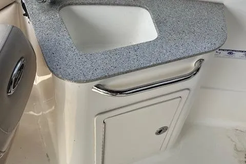 Slide: The Image of 2012 Chaparral 225 SSi boat interior with sink and storage compartment. - 6