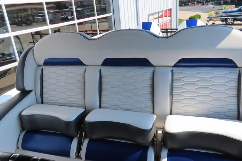Slide: The Image of 2021 Sunsation 34 CCX boat interior seating with modern design and blue accents. - 17