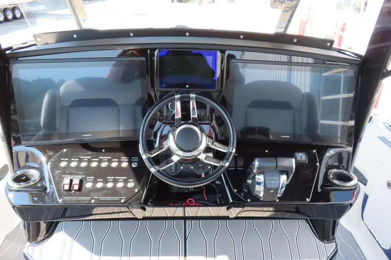 Slide: The Image of 2021 Sunsation 34 CCX helm with dual Garmin displays and modern controls. - 18