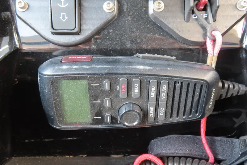 Slide: The Image of Garmin marine radio on 2021 Sunsation 34 CCX dashboard with distress button. - 27