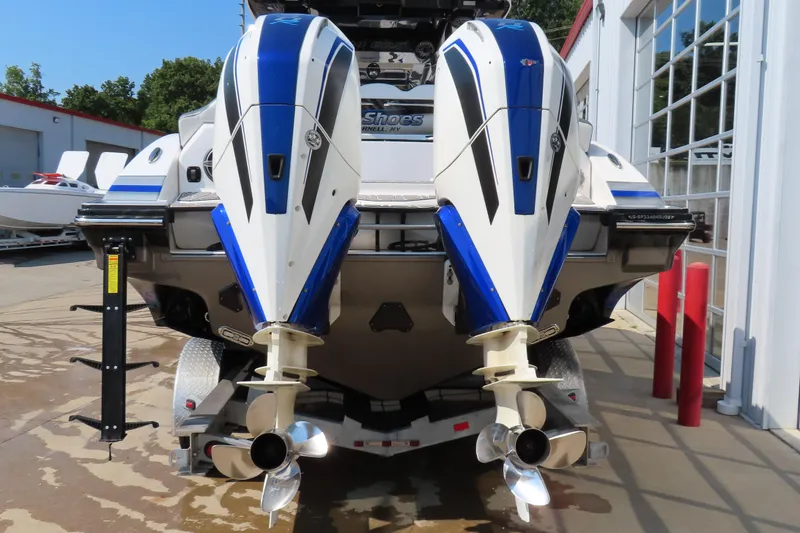 Slide: The Image of 2021 Sunsation 34 CCX boat with dual outboard motors, docked at a marina. - 5