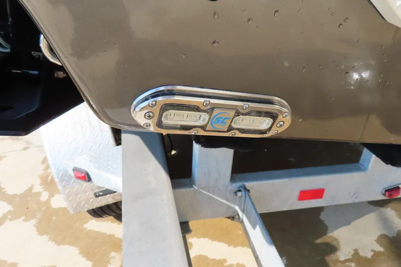 Slide: The Image of 2021 Sunsation 34 CCX boat detail with trailer, featuring a sleek design and lighting. - 7