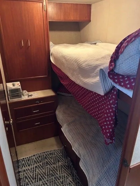 Slide: The Image of 1984 Post 43 Sport Fisherman cabin with bunk beds and wooden cabinetry. - 13