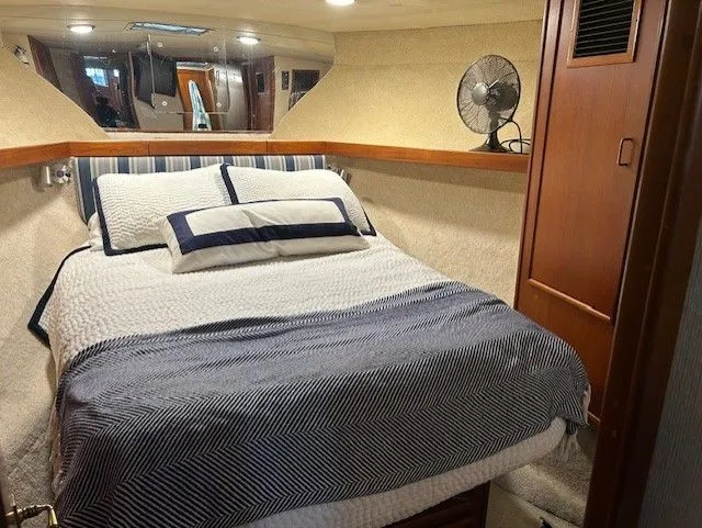 Slide: The Image of Cozy cabin interior of 1984 Post 43 Sport Fisherman with bed and fan. - 15