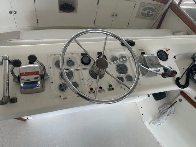 Slide: The Image of 1984 Post 43 Sport Fisherman helm with steering wheel and control panel. - 7
