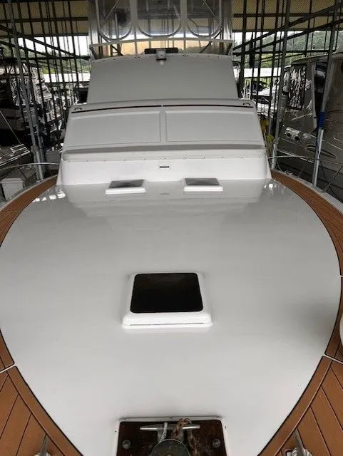 Slide: The Image of 1984 Post 43 Sport Fisherman boat deck with white surface and wooden trim. - 8