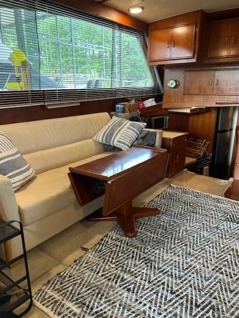 Slide: The Image of Interior of 1984 Post 43 Sport Fisherman with sofa, table, and kitchen area. - 9