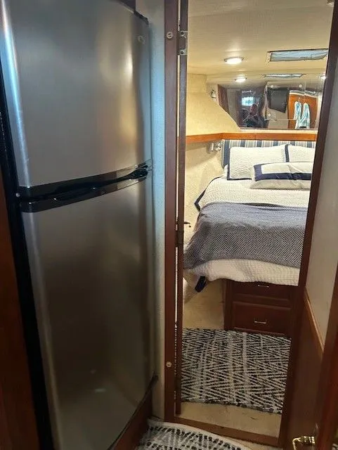 Slide: The Image of Interior of 1984 Post 43 Sport Fisherman with bed and stainless steel fridge. - 14