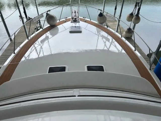 Slide: The Image of 1984 Post 43 Sport Fisherman boat deck with wooden trim and docked at a marina. - 6