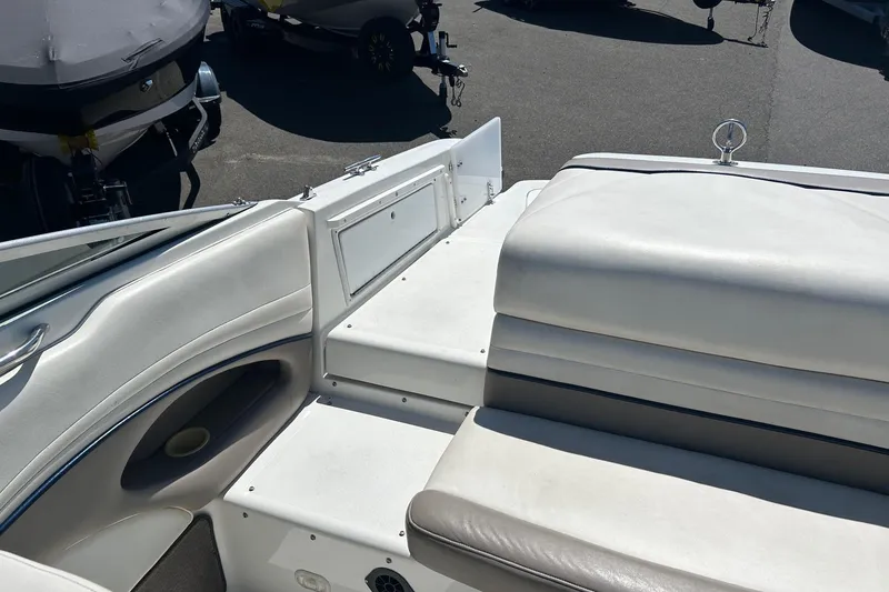 Slide: The Image of Interior view of a 2001 Cobalt 227 boat with white seating and storage compartments. - 13