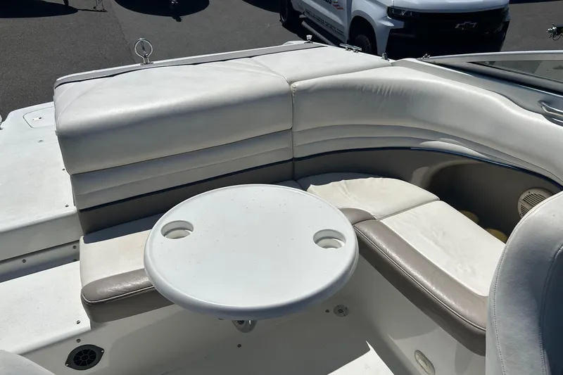 Slide: The Image of 2001 Cobalt 227 boat interior with white seating and round table. - 14