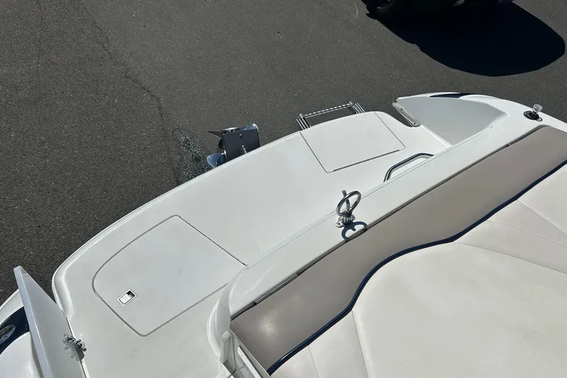 Slide: The Image of 2001 Cobalt 227 boat deck with white seating and storage compartments. - 15