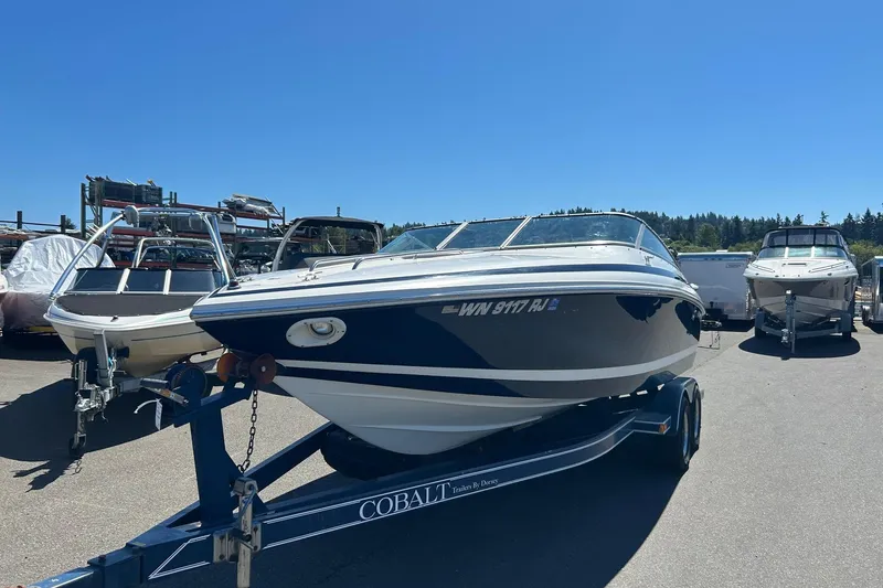 Slide: The Image of 2001 Cobalt 227 boat on trailer in sunny outdoor setting. - 16