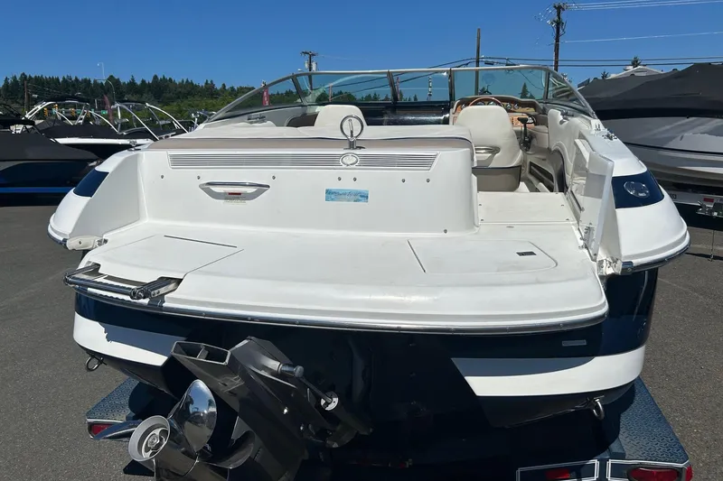 Slide: The Image of 2001 Cobalt 227 boat, rear view, parked outdoors on a sunny day. - 17