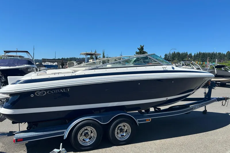 Slide: The Image of 2001 Cobalt 227 boat on trailer under clear blue sky. - 2