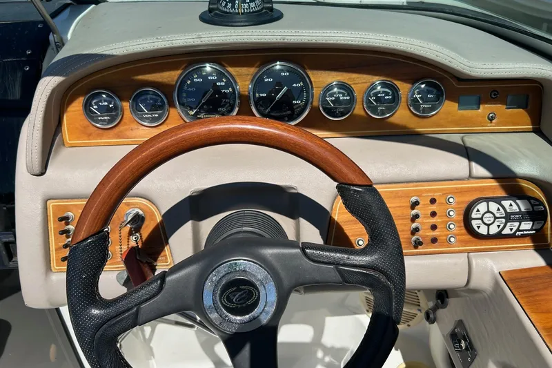Slide: The Image of Dashboard of a 2001 Cobalt 227 boat with wood accents and gauges. - 3