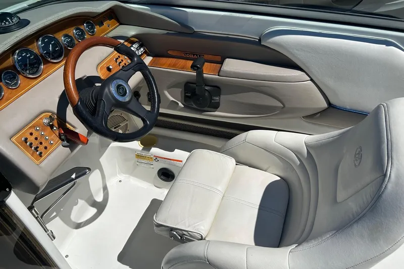 Slide: The Image of Interior of a 2001 Cobalt 227 boat with wood accents and leather seating. - 4
