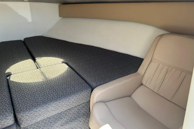 Slide: The Image of Interior of a 2001 Cobalt 227 boat with cushioned seating and upholstery. - 9