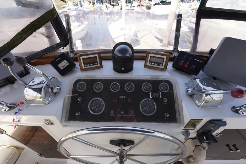 Slide: The Image of 1986 Ocean Alexander 40 Double Cabin helm with gauges, controls, and steering wheel. - 10