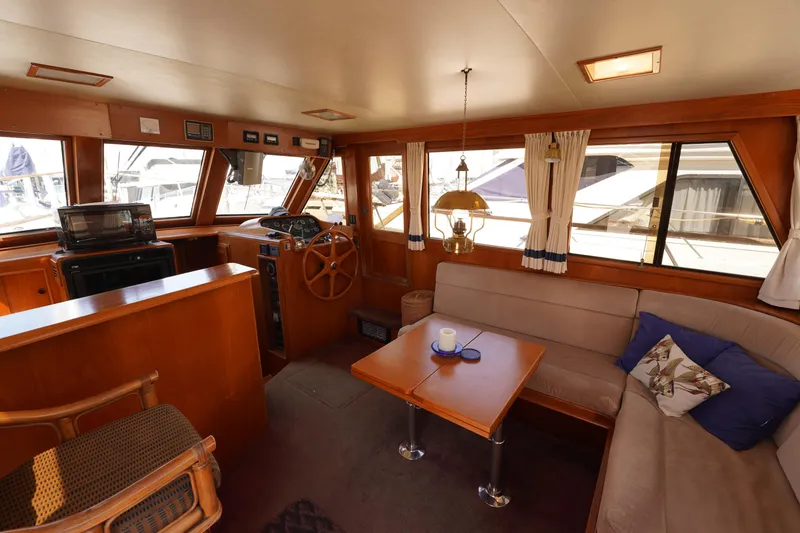 Slide: The Image of Interior of 1986 Ocean Alexander 40 Double Cabin with cozy seating and wooden accents. - 12