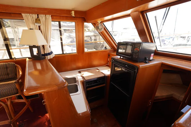Slide: The Image of Interior of 1986 Ocean Alexander 40 Double Cabin with kitchen and seating area. - 17