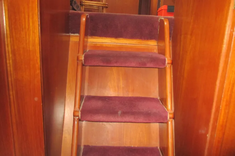 Slide: The Image of Staircase inside 1986 Ocean Alexander 40 Double Cabin yacht with wooden finish and carpeted steps. - 28