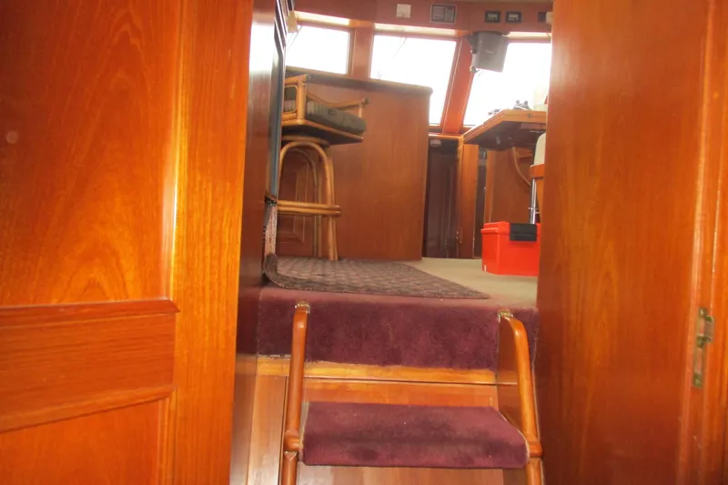 Slide: The Image of Interior view of 1986 Ocean Alexander 40 Double Cabin with wooden finishes and seating area. - 29