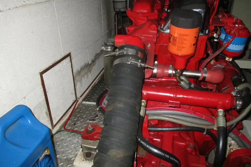 Slide: The Image of Engine compartment of a 1986 Ocean Alexander 40 Double Cabin yacht, featuring red engine components. - 33