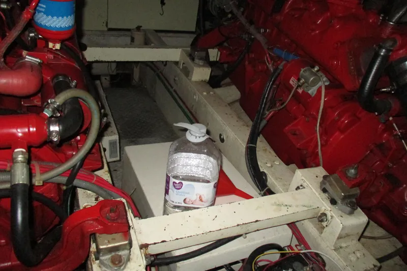 Slide: The Image of Engine room of 1986 Ocean Alexander 40 Double Cabin with red machinery and a water bottle. - 35