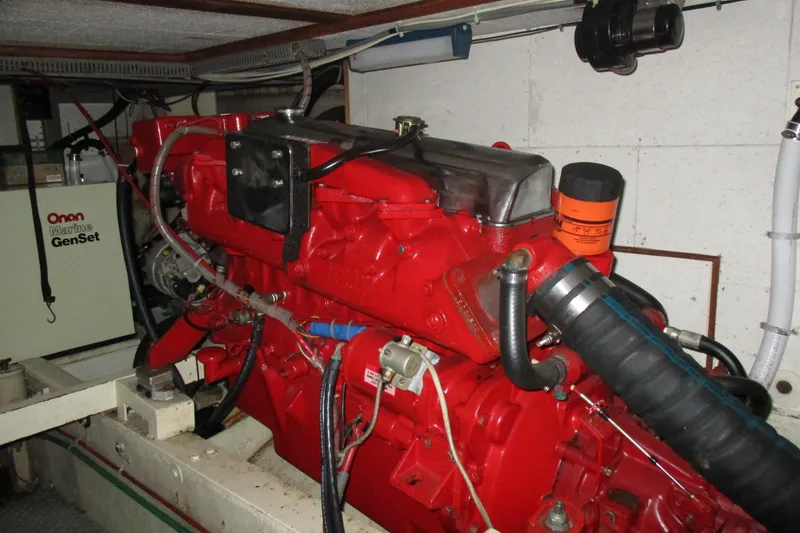 Slide: The Image of Engine room of 1986 Ocean Alexander 40 Double Cabin with red marine engine and Onan generator. - 37