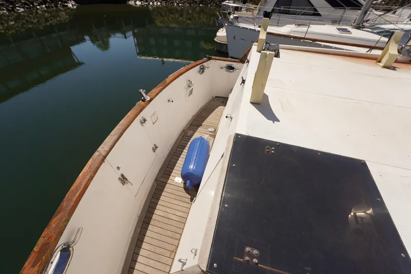 Slide: The Image of 1986 Ocean Alexander 40 Double Cabin yacht deck with wooden railing and blue fender. - 4