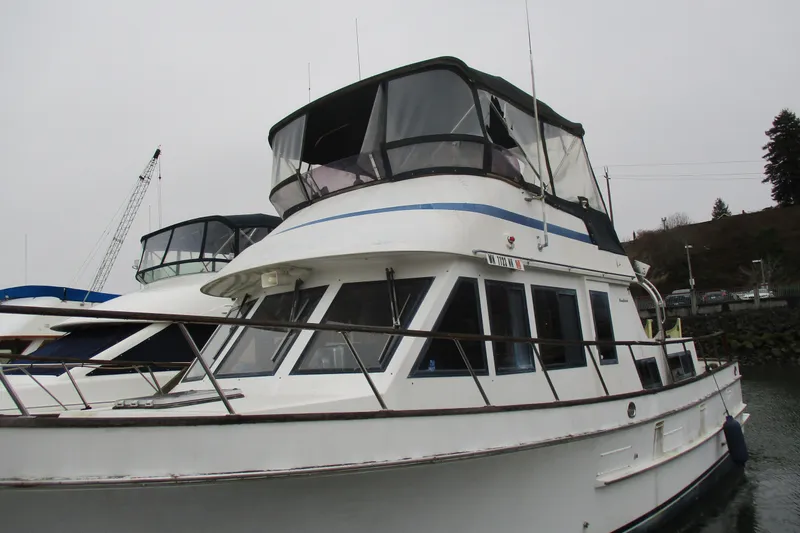 Slide: The Image of 1986 Ocean Alexander 40 Double Cabin yacht docked in a marina. - 48