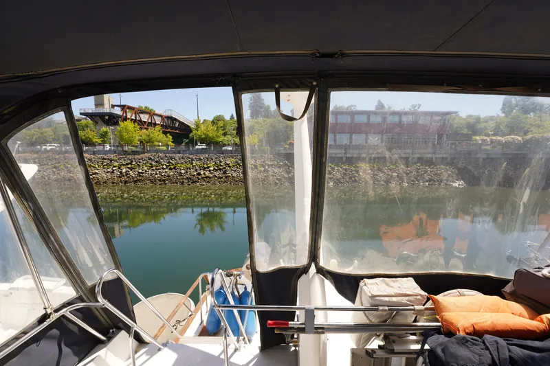 Slide: The Image of 1986 Ocean Alexander 40 Double Cabin interior view with waterfront and bridge. - 9