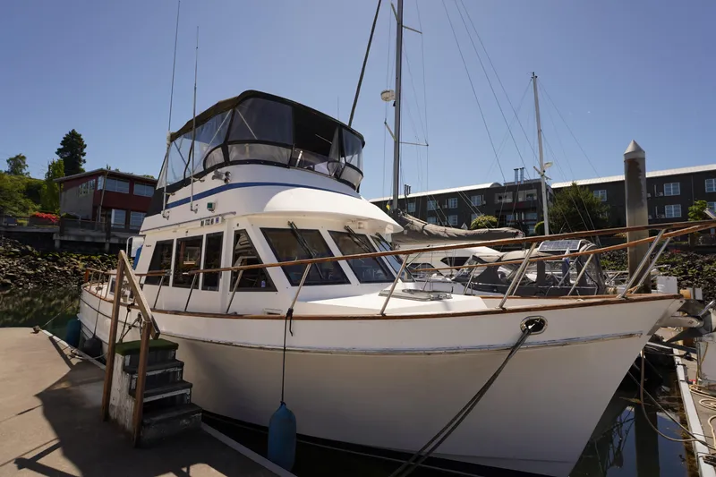 The Image of 1986 Ocean Alexander 40 Double Cabin yacht docked at marina under clear blue sky. - 1