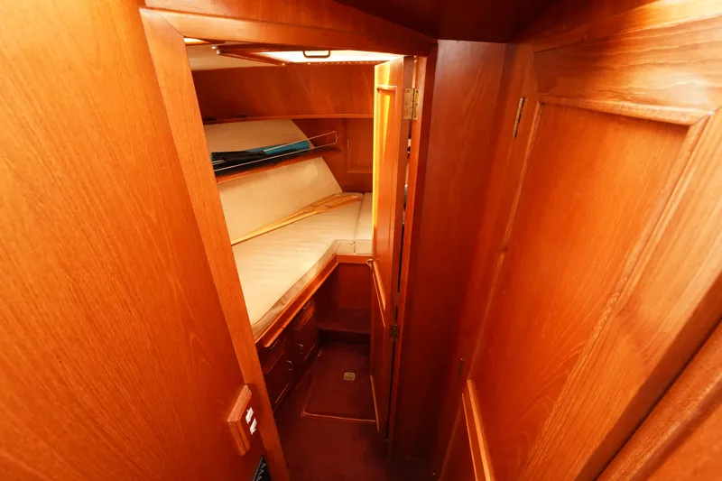 Slide: The Image of 1986 Ocean Alexander 40 Double Cabin interior with wooden finish and cozy sleeping area. - 18