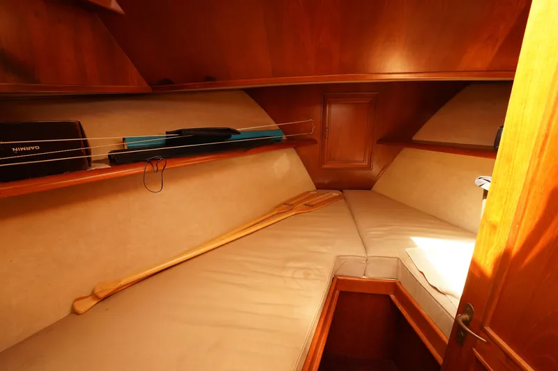 Slide: The Image of 1986 Ocean Alexander 40 Double Cabin interior with cozy wooden furnishings and storage shelves. - 19
