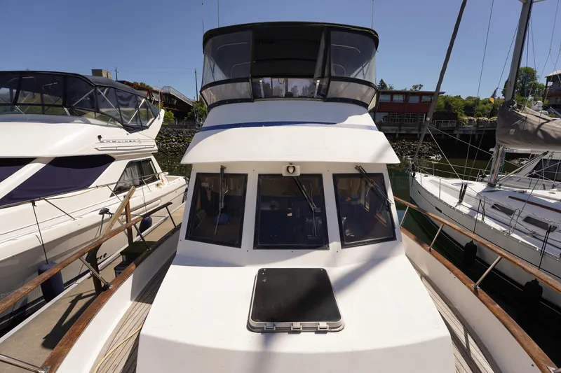 Slide: The Image of 1986 Ocean Alexander 40 Double Cabin yacht docked between other boats. - 2