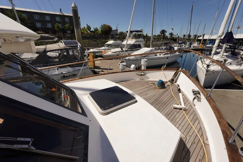 Slide: The Image of 1986 Ocean Alexander 40 Double Cabin yacht docked at marina, surrounded by other boats. - 3